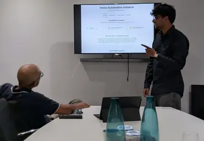 Me presenting the Innovi Automation Initiative on a screen in a meeting room.