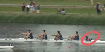 A rowing four racing on a river, with the cox circled in red.