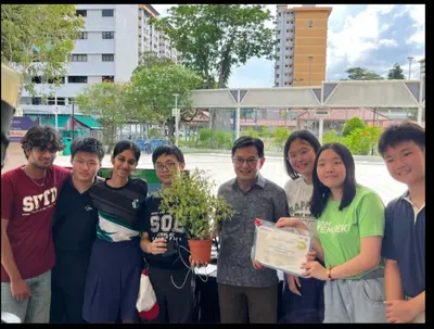 Me with the STEAMunity student team and Deputy Prime Minister Heng Swee Keat, the students holding their award and their plant sensor project.